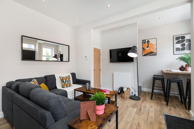 Bright Contemporary Living Room With A Charcoal L-...