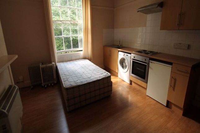 A Cozy Bedroom Featuring A Single Bed And A Window...