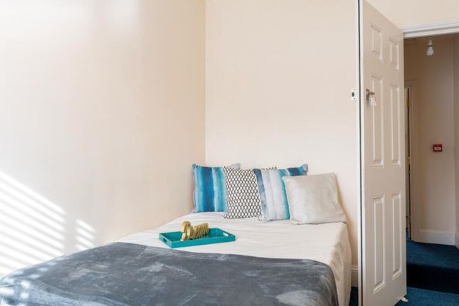 A Cozy Double Bedroom Featuring Large Windows That...