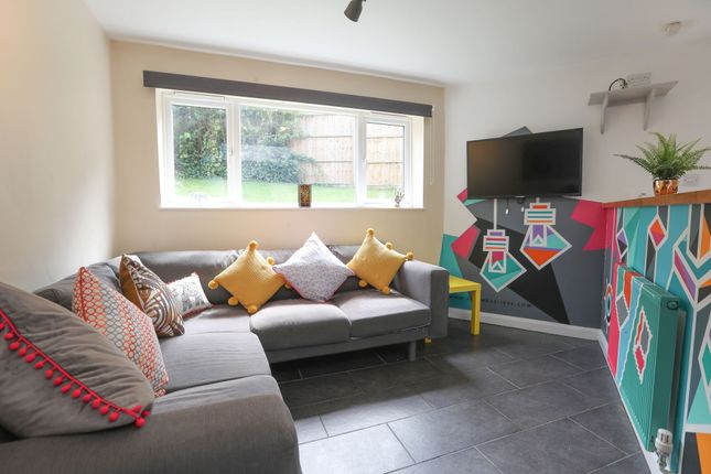 This Cozy Living Room Features A Stylish Grey Sofa...