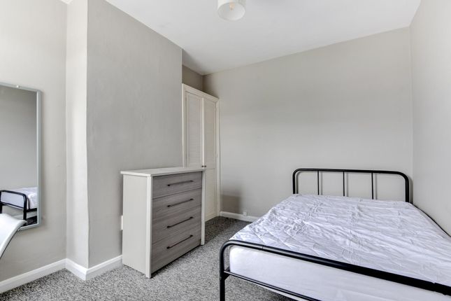 A Bright And Tidy Small Bedroom Featuring A Metal ...