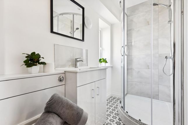 A Bright And Modern Bathroom Featuring A Sleek Sho...