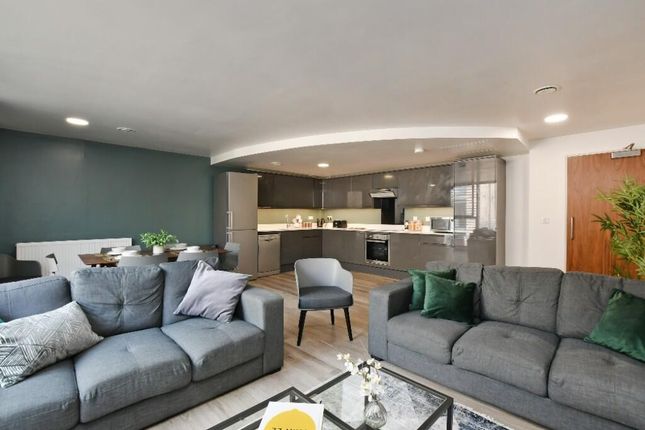 A Spacious And Modern Living Room Featuring Comfor...