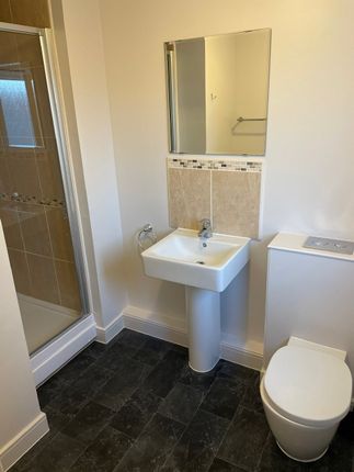 A Clean And Modern Bathroom Featuring A Walk-In Sh...