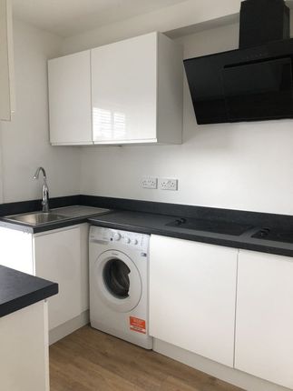 Bright And Modern Kitchen Featuring Sleek White Ca...