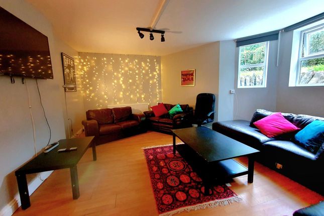 A Cozy, Well-Lit Living Room Featuring Comfortable...