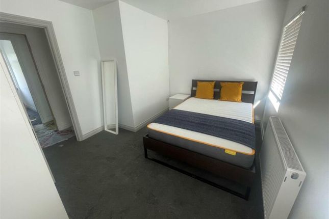 A Clean And Well-Lit Double Bedroom Featuring A Be...