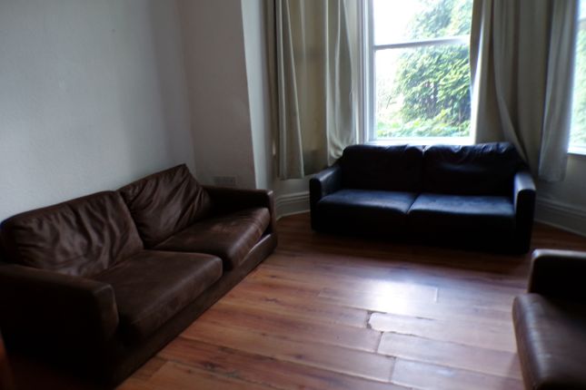 A Spacious And Inviting Living Room With Ample Sea...