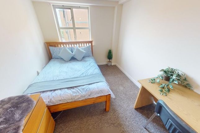 A Cozy Single Bedroom Featuring A Comfortable Bed ...