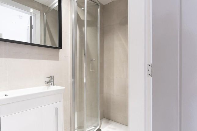 A Clean, Well-Maintained Bathroom Featuring A Show...