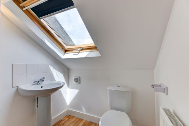 A Bright And Clean Bathroom With A White Toilet An...