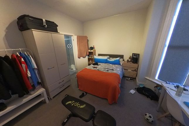 A Cozy Single Bedroom Featuring A Neatly Made Bed ...