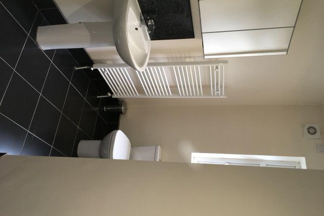 A Modern Bathroom Suite Featuring A Clean White Si...