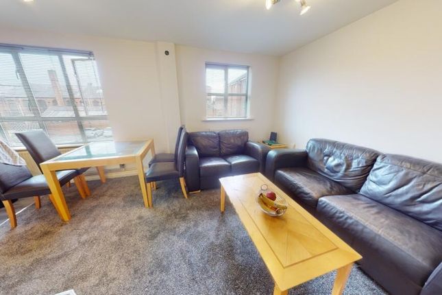 A Bright And Inviting Living Room Featuring Comfor...