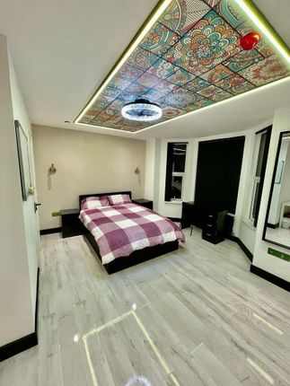 A Stylish Double Bedroom Featuring A Comfortable B...
