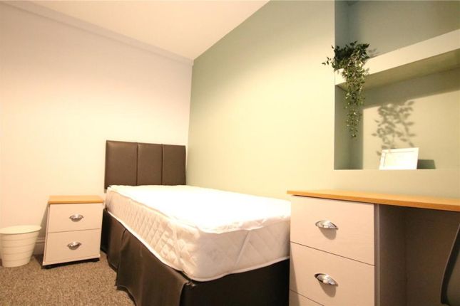 A Cozy Double Bedroom Featuring A Sleek Design And...