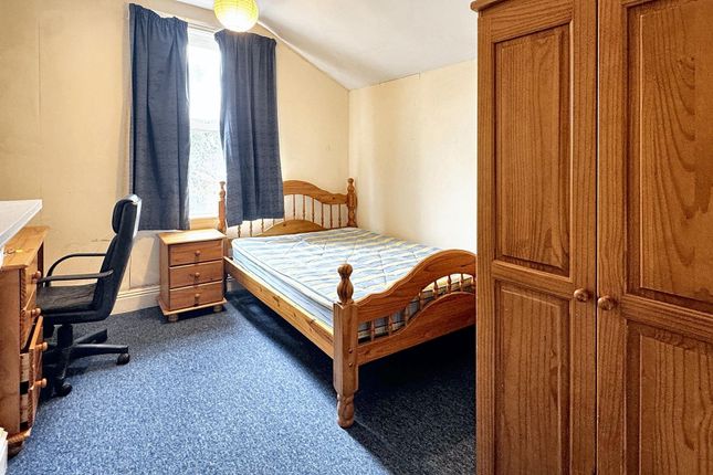A Cozy, Well-Maintained Bedroom Featuring A Wooden...