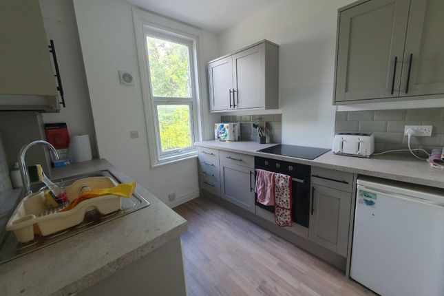 A Modern Kitchen Featuring Sleek Cabinetry And Int...