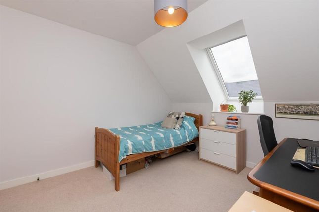 A Neat And Bright Single Bedroom Featuring A Comfo...