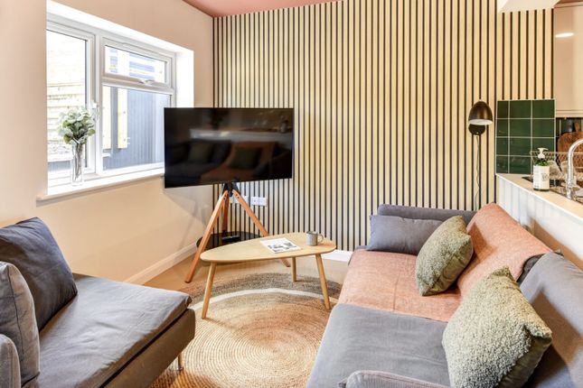 Experience A Cozy And Stylish Living Room Featurin...