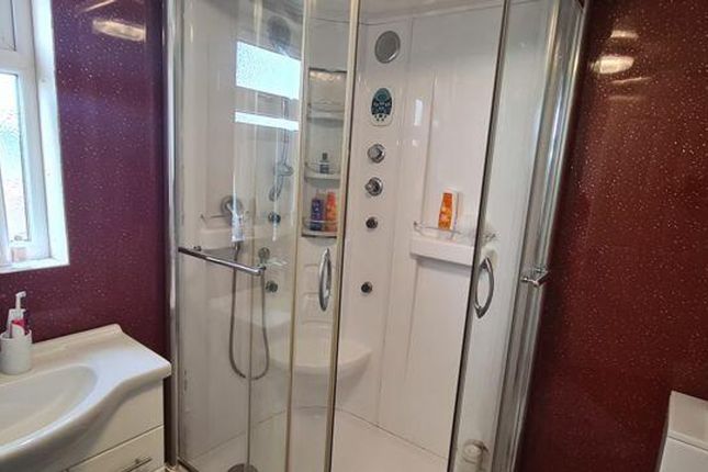 A Modern Bathroom Featuring A Spacious Shower And ...