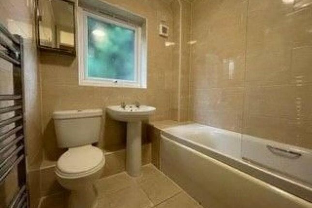 A Well-Maintained Bathroom Featuring A Modern Whit...