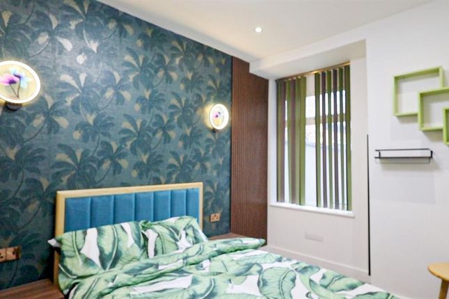 A Stylish Double Bedroom Featuring A Cozy Double B...