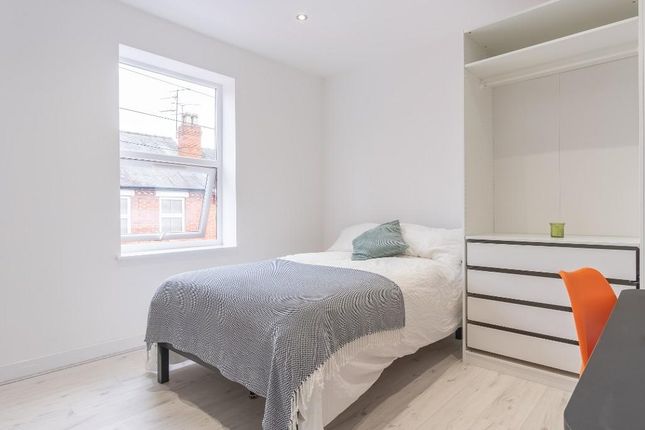 A Bright And Tidy Single Bedroom Featuring A Comfo...