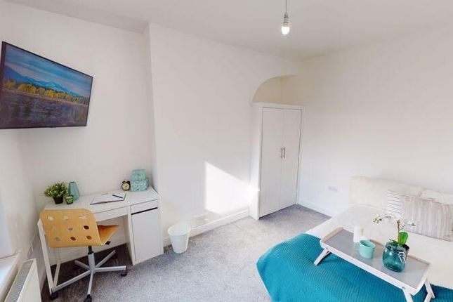 A Bright And Tidy Bedroom Featuring A Comfortable ...