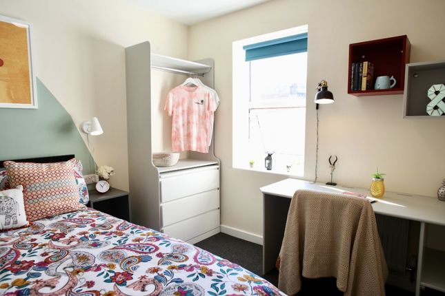 This Cozy Double Bedroom Features A Vibrant Decor,...