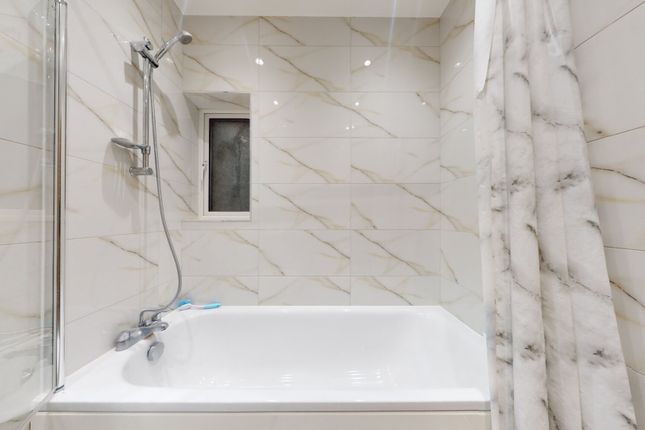 Bright, Modern Bathroom With A Full Bathtub And Ov...