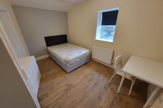 This Inviting Double Bedroom Features A Comfortabl...