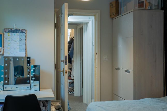 A Tidy Bedroom With Natural Light Coming Through T...