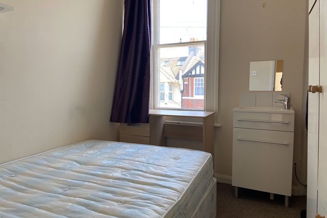 A Well-Maintained Bedroom Featuring A Large Window...