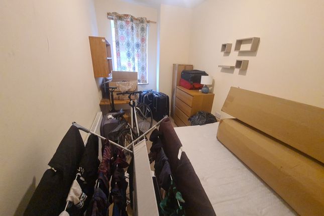 A Compact Bedroom Featuring A Single Bed With Ligh...