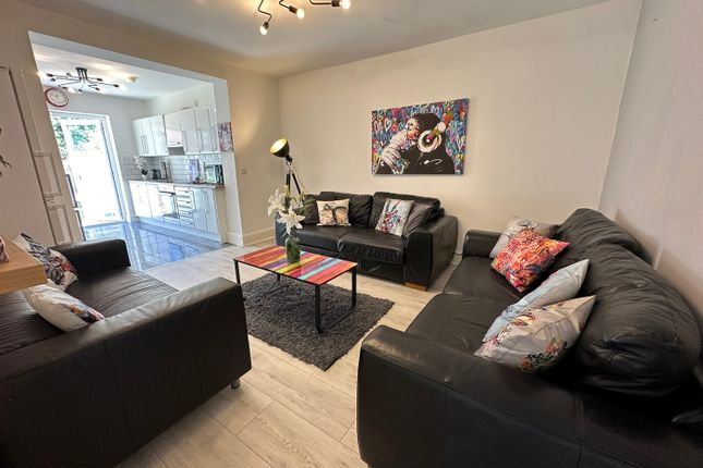 A Stylish Living Room Featuring Comfortable Black ...