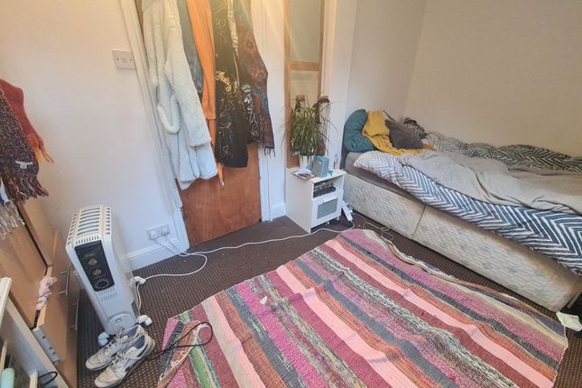 A Cozy Single Bedroom Featuring A Comfortable Bed,...