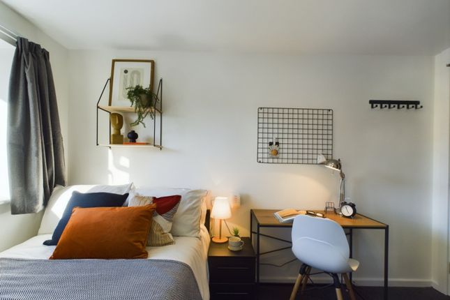 A Bright And Inviting Double Bedroom With A Cozy A...