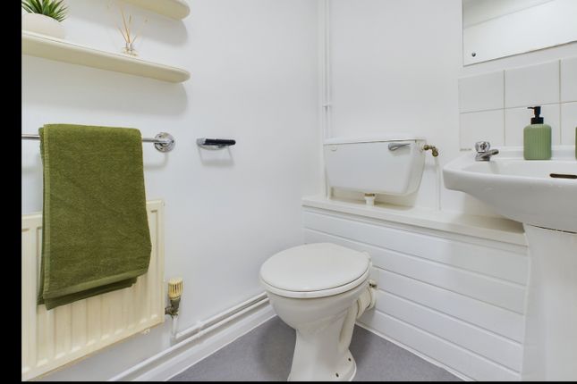 A Bright And Tidy Bathroom Featuring Modern Fixtur...