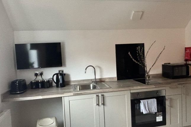 This Modern Kitchen Features Sleek Cabinetry And A...