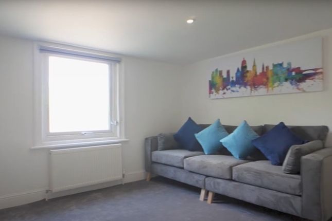 Bright And Inviting Living Room Featuring A Comfor...