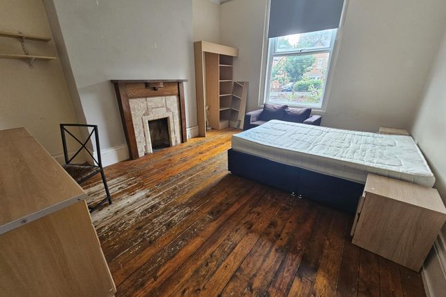 A Cozy Single Bedroom With A Large Window Offering...