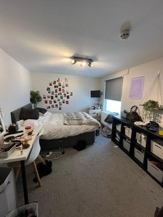 A Spacious, Well-Lit Living Room Featuring Several...