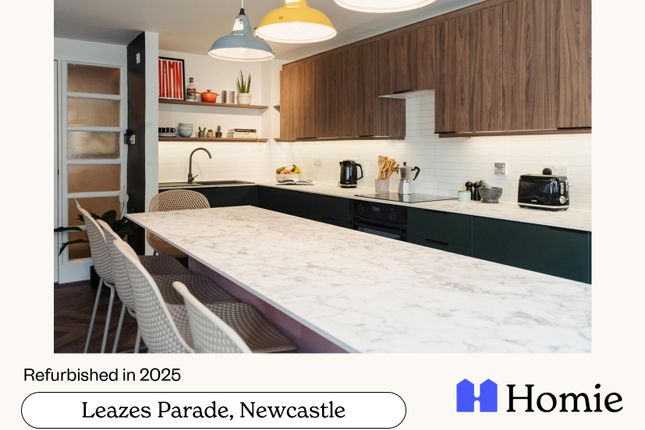 A Modern, Well-Lit Kitchen With A Large Island, Sl...