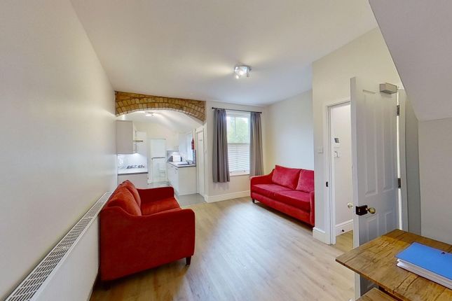 Bright Furnished Living Room With Two Vibrant Red ...