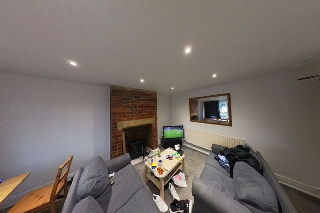 A Spacious And Inviting Living Room With Modern Fu...