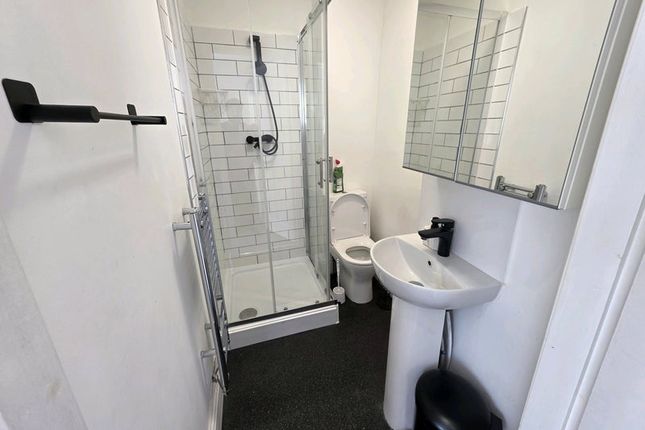 A Clean And Modern Bathroom Featuring A Glass-Encl...