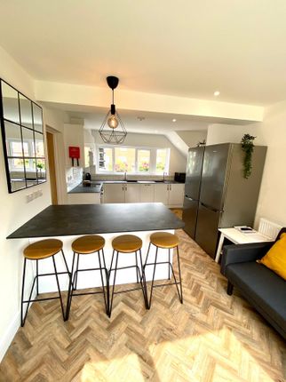 A Bright And Modern Kitchenette With Stylish Seati...