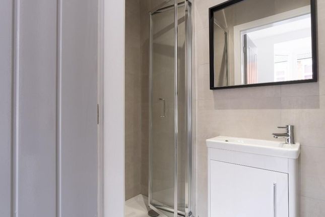 A Clean And Well-Maintained Bathroom With A Glass ...