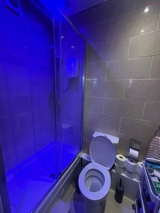 A Clean And Modern Bathroom Featuring A Toilet And...